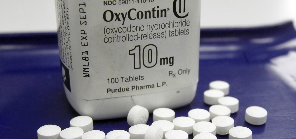 A bottle of OxyContin with pills scattered around