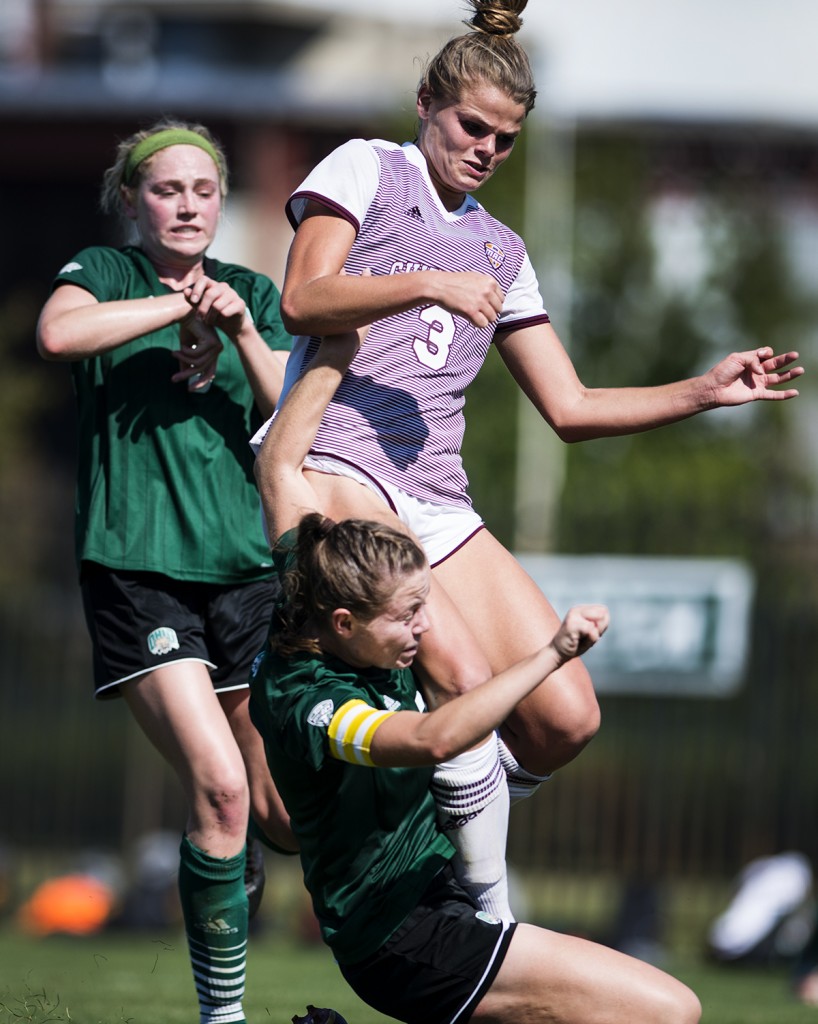 Central Michigan's forward Lexi Pelefas, center, jumps into two Bobcat players during their game on September 24, 2017 in Athens, Ohio. The Bobcats won the game 3-0. (Kelsey Brunner/WOUB)