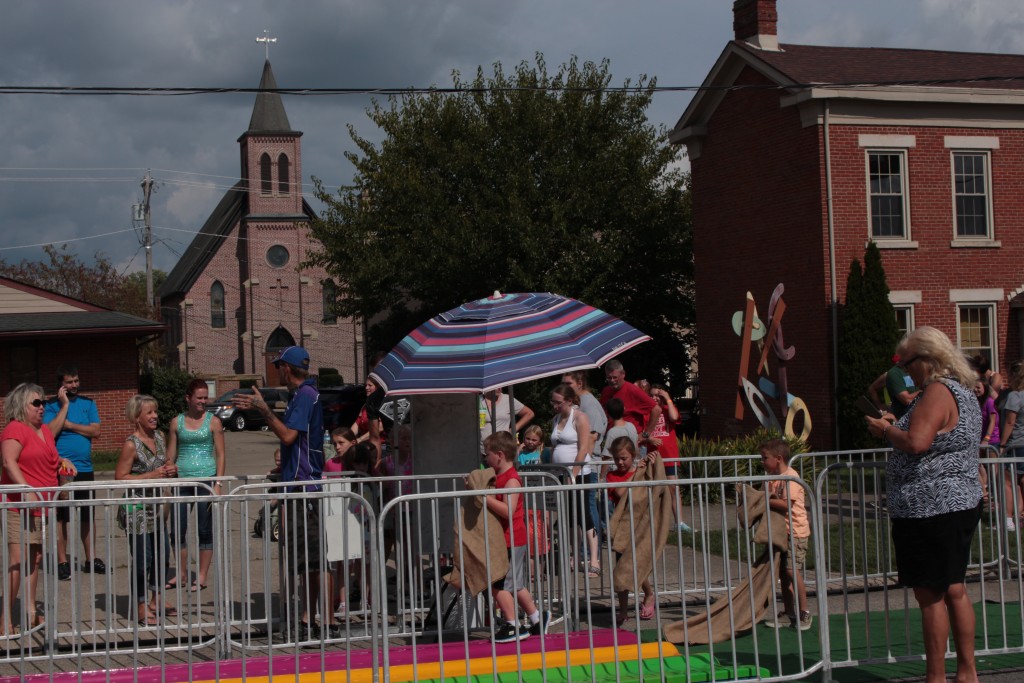 Kids and adults worm their way into the line for the Fun Slide. (WOUB/Emily Votaw) 