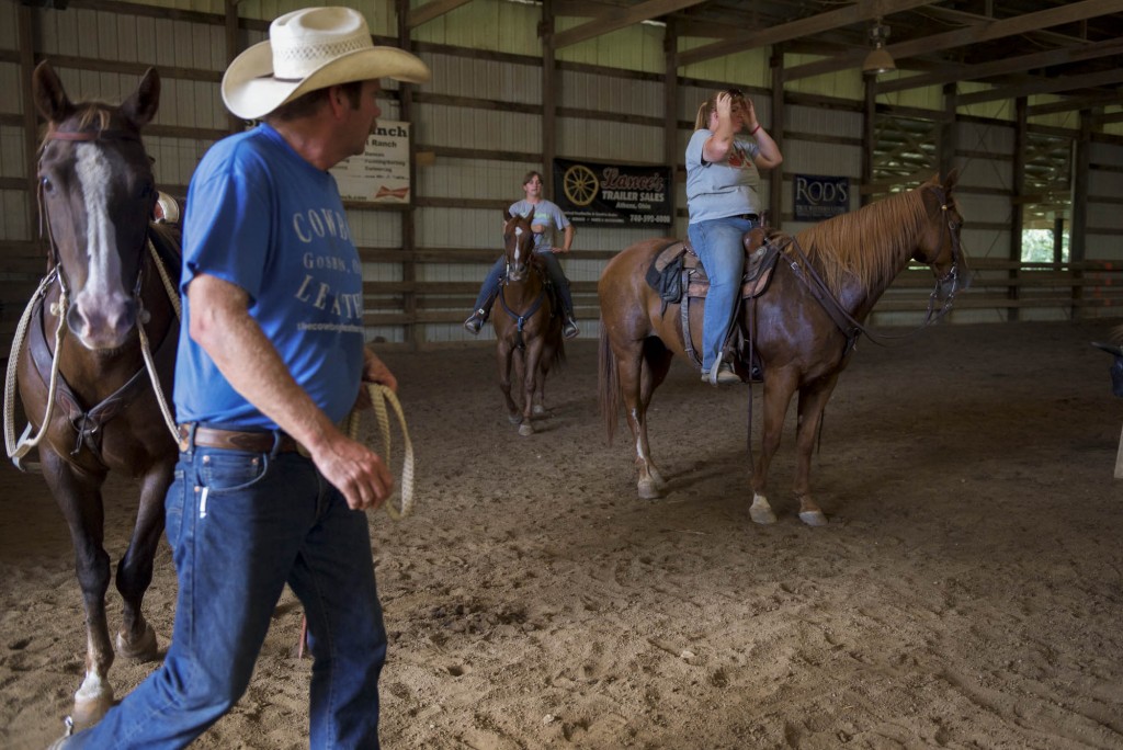 Charlie Schoonover, Lexy Snow, and Shae Nelson start to gather up the horses to put them in their stables after a long weekend of hosting Cowgirl Boot Camp. (WOUB/Daniel Linhart)