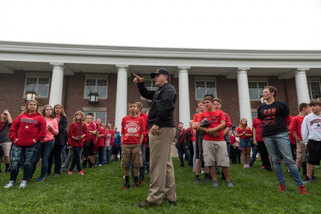 Vietnam Veteran and volunteer, Dick Holmes, orders Crooksville students where they will be going for their first tour at "The Wall That Heals". (Nickolas Oatley/WOUB)