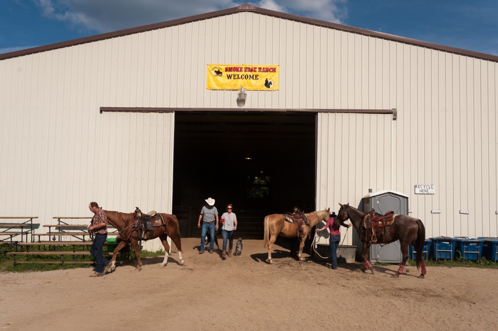 Cowboys and cowgirls walk out of the indoor arena after an advanced horsemanship class at Smoke Rise Ranch on Friday, September 22, 2017. (Michael Swensen/WOUB)