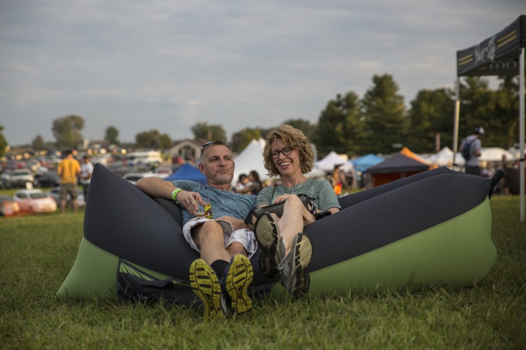 Brian Honican (left) and his wife, Laura Schumacher enjoy the band live show in Pawpaw festival in Albany, Ohio on Sep. 16, 2017.(Wangyuxuan Xu/WOUB)