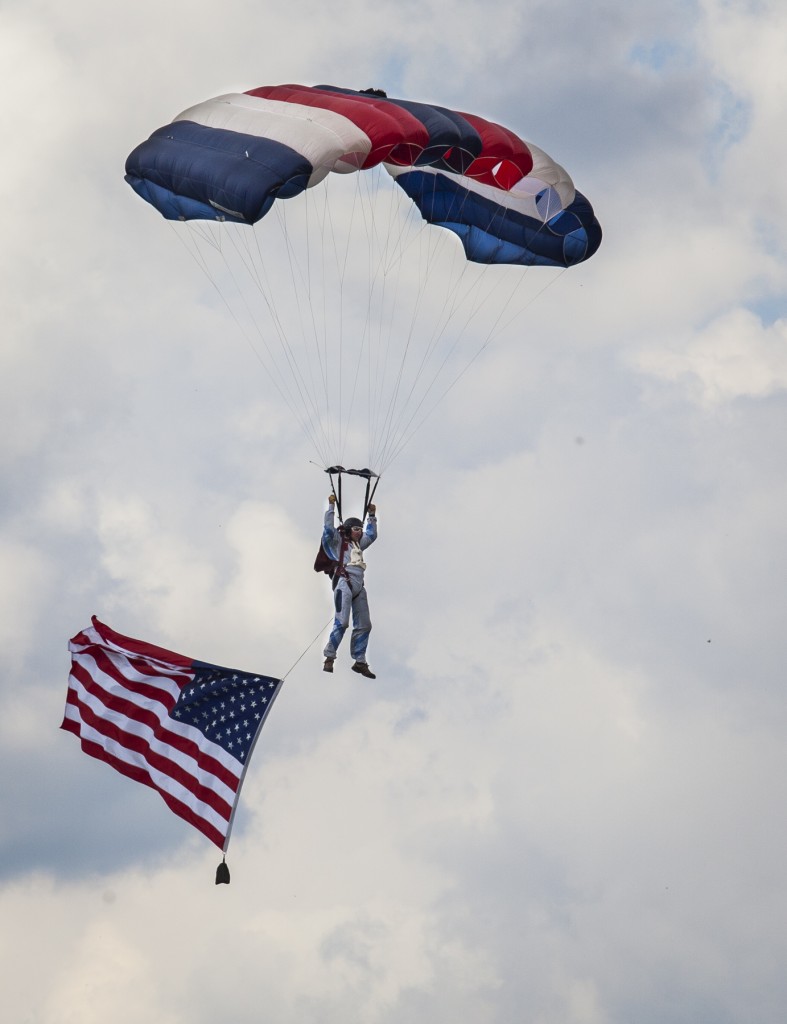 A skydiver decends from the sky during the National Anthem at the start of the Vinton County Air Show on Sunday, September 17, 2017. (Erin Clark/WOUB)