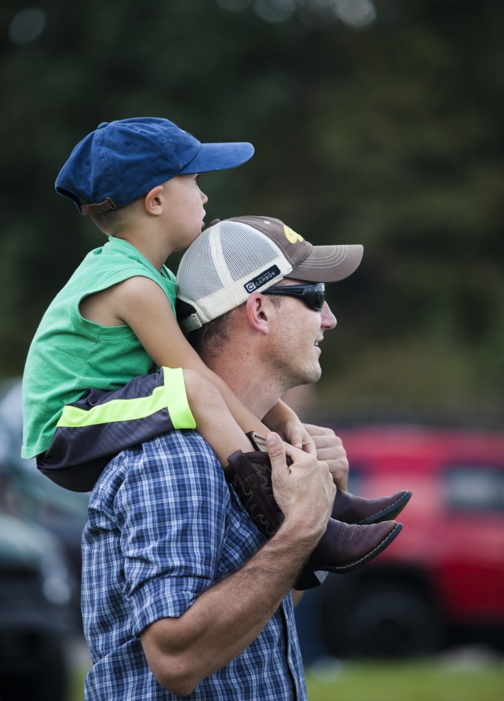 Joe Banks watches the air show at the Vinton County Airport with his son, Jake, 3, on Sunday, September 17, 2017. (Erin Clark/WOUB)