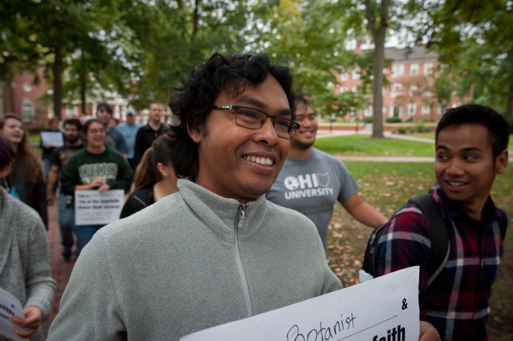 Bina Sitepu and his friend, Dimas Philipinanto (right) walk through College Green with others attending the Interfaith Peace Walk. Both are from Indonesia, and came to Athens to study botany. Dimas says that he doesnt believe in God, but that he wants people to exist in peace. (Drake S. Withers / WOUB)