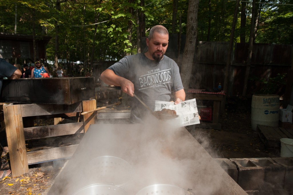 Cory Haberkamp serves stew at the "Bayou Boil," a booth that his family runs at the Backwoods Fest in Thornville, Ohio.