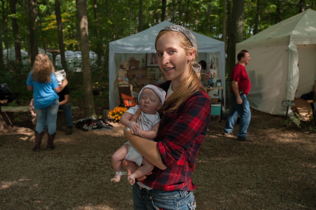 Bethany Wiseman displays one of her realistic baby dolls (known as "reborn dolls" at the Backwoods Fest in Thornville, Ohio. At 20 years old, Bethany is the youngest business owner in Ohio (as of January 2017).