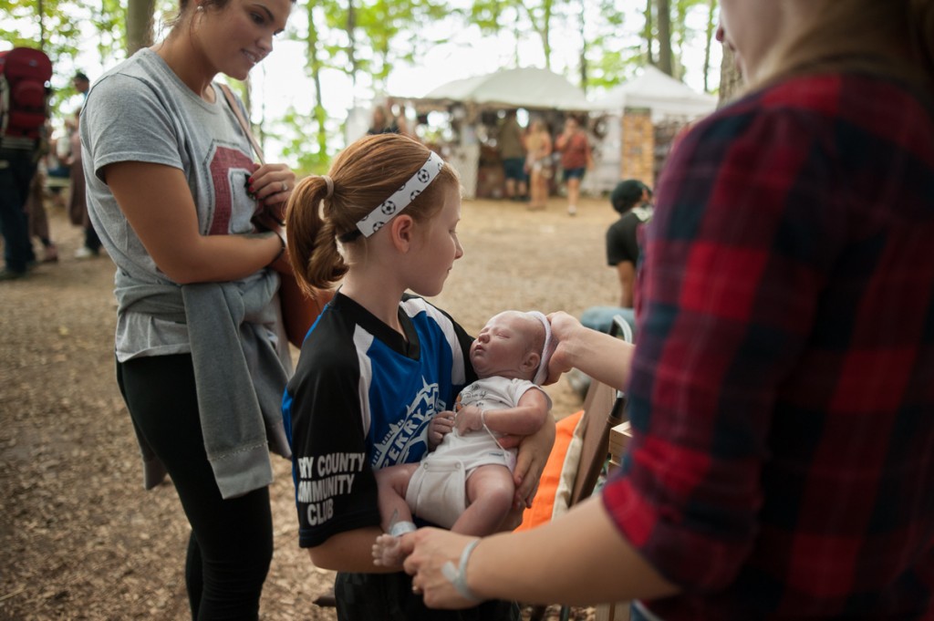 Bethanie Wiseman (right) shows Lindsay (left) and Rylan Gray one of her realistic baby dolls (known as "reborn dolls") at the Backwoods Fest in Thornville, Ohio.