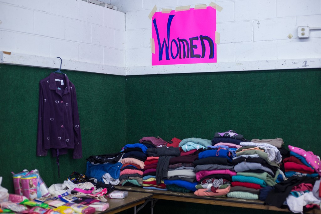 Clothing rests on tables in one of the main donation buildings for local residents who are homeless, at risk of becoming homeless and local veterans at the Athens County Fairgrounds. (HANNAH SCHROEDER | FOR WOUB)