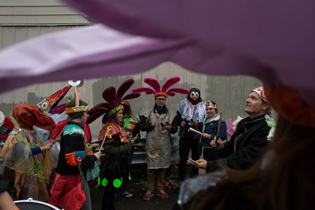 Eric "The Fish" Paton leads a group of students and community volunteers in his version of Brazilian Percussion moments before the parade begins on Court Street on October 28, 2017.  (Michael Johnson/WOUB)