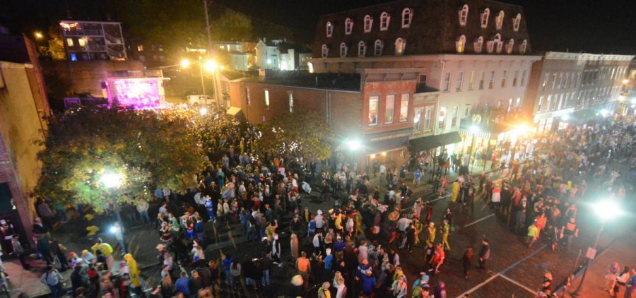 Students walk along Court Street during the Halloween Block Party