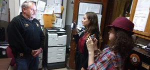 Two students interview former Meigs County Sheriff Keith Wood in his office.