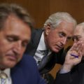 Sens. Jeff Flake, R-Ariz., Bob Corker, R-Tenn., and Ron Johnson, R-Wis., seen at a hearing earlier this month, held up floor action on Thursday evening over concerns about how to control the deficit if the GOP tax bill doesn't result in strong economic growth.