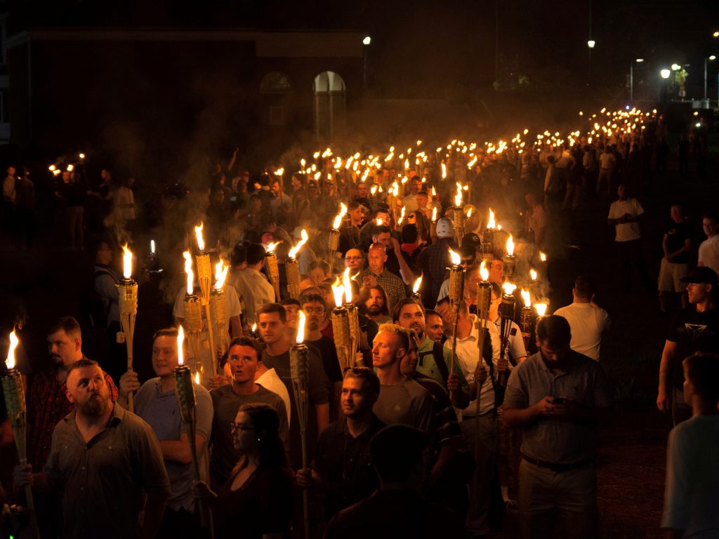 White nationalists carry torches on the eve of a Unite The Right rally in Charlottesville, Va., on Aug. 11.