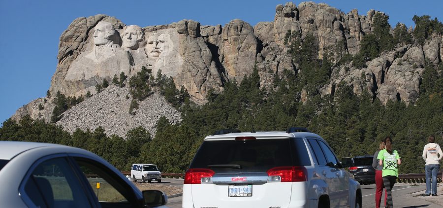 During the 2013 shutdown, tourists have to look at Mount Rushmore from the highway because the national memorial in Keystone, S.D., was closed.