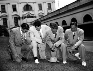 Though Graham always declared himself to be politically neutral, he hovered around the edges of the nation's politics, praying here on the White House lawn on July 14, 1950, asking divine aid for then-President Harry S. Truman in his handling of the Korean crisis. From left are Jerry Beavan, Graham, Clifford Barrows and Grady Wilson.