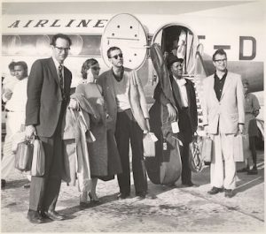 The Dave Brubeck Quartet on tour in 1958 standing in front of airplane