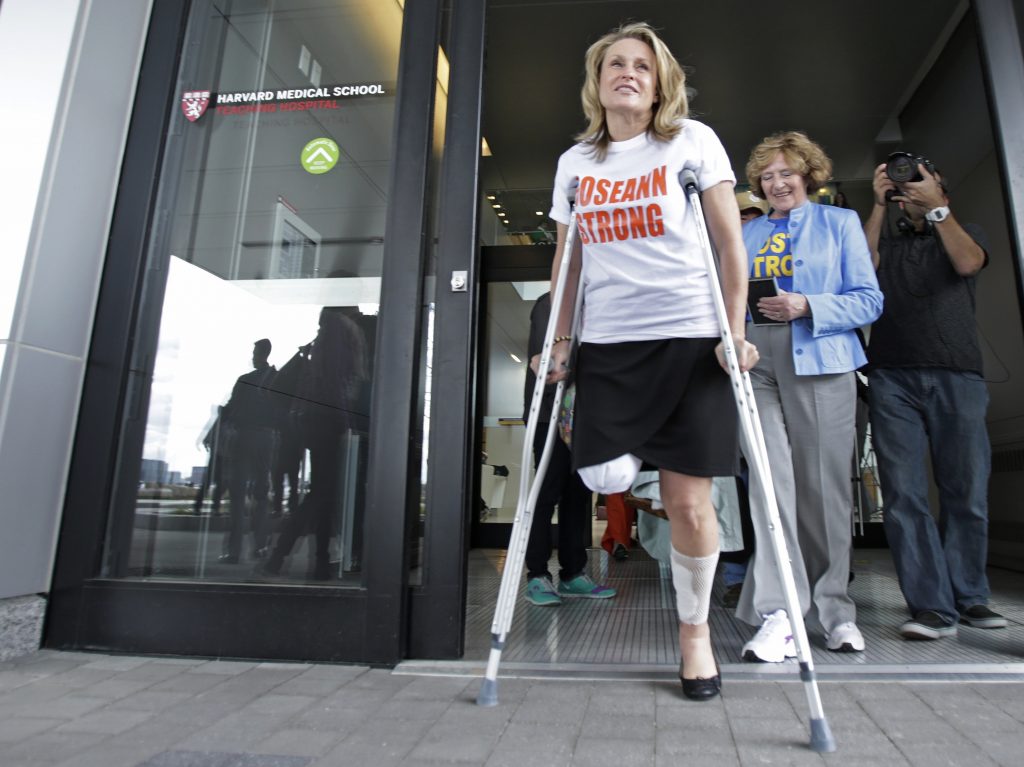 Roseann Sdoia leaves Spaulding Rehabilitation Hospital in Boston in May 2013 after losing part of her right leg in the explosions near the finish line of the Boston Marathon.