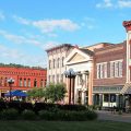 Photo of town square in Nelsonville Ohio. The town's fountain in on the left hand side of the image with buildings on the right.