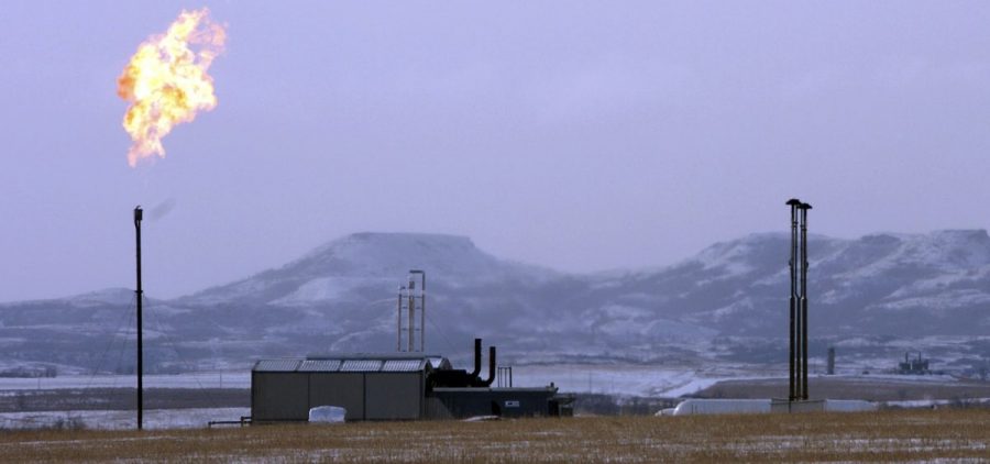 A gas flare is seen at a natural gas processing facility near Williston, N.D. in 2015. A new study says the amount of methane leaking is more than government estimates.