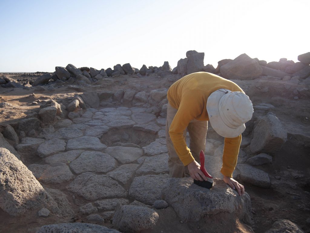 A researcher gathers breadcrumbs at an excavation site in Jordan. The 14,000-year-old crumbs suggest that ancient tribes were quite adept at food-making techniques, and developed them earlier than we had given them credit for.