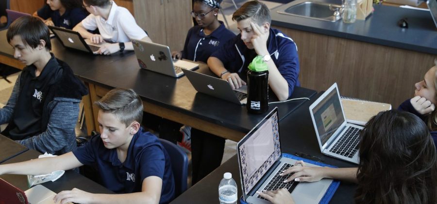 Students work on computers in Henderson, Nev. Several states including Utah and Ohio use automated grading on student essays written as part of standardized tests.