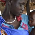 Elizabeth Nyakoda holds her 10-month-old daughter at a feeding center for children in South Sudan.