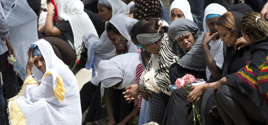 Women grieve as the coffin of one of the 24 migrants who drowned while trying to reach Italy, is buried in Santa Maria Addolorata Cemetery on the outskirts of Valletta, Malta, on April 23, 2015. The migrants died as a smuggler's boat crammed with hundreds of people overturned off the coast of Libya.