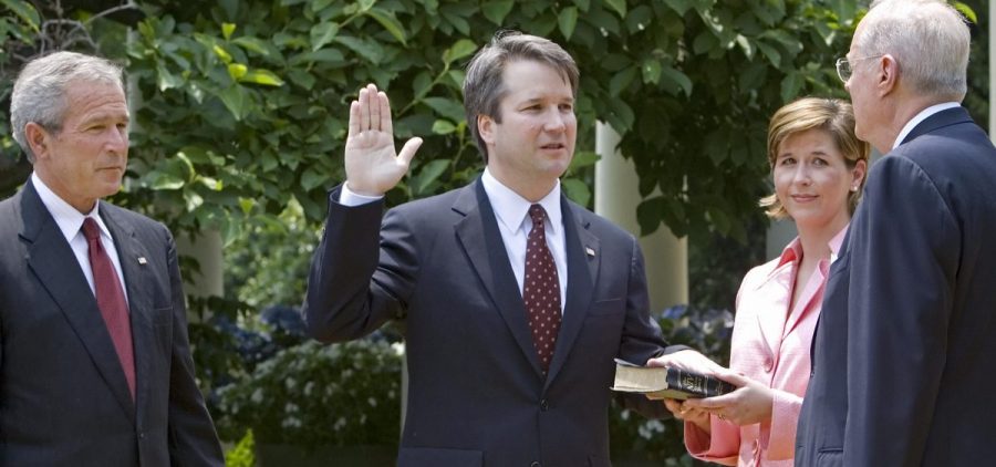 Brett Kavanaugh is sworn in as a federal judge by Supreme Court Justice Anthony Kennedy in 2006. President George W. Bush looks on. Kavanaugh is Trump's pick to replace Kennedy on the Supreme Court.