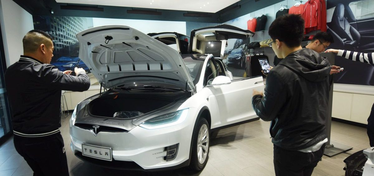 Customers look at Tesla cars at a showroom in Hangzhou in China's eastern Zhejiang province on April 4. The cut in Chinese auto import tariffs could help Tesla, which has been looking to break into the Chinese market.
