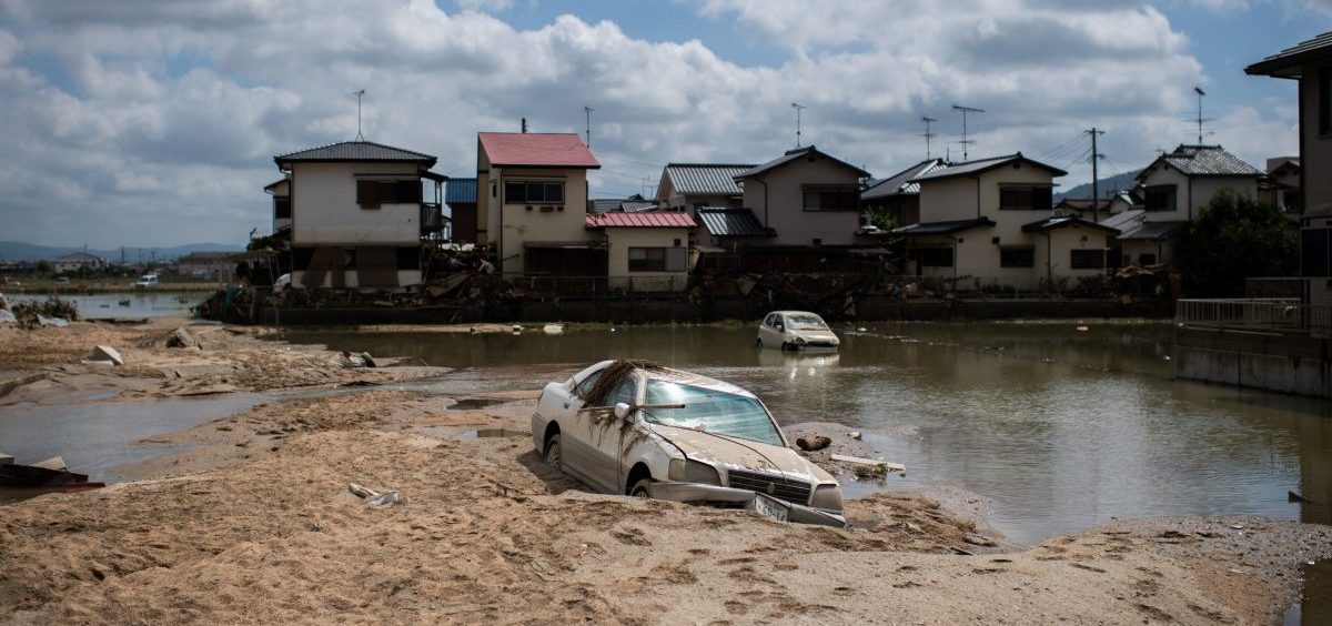 A damaged car is seen stuck in the mud in a flood-hit area in Mabi, in Japan's Okayama prefecture, on Tuesday.