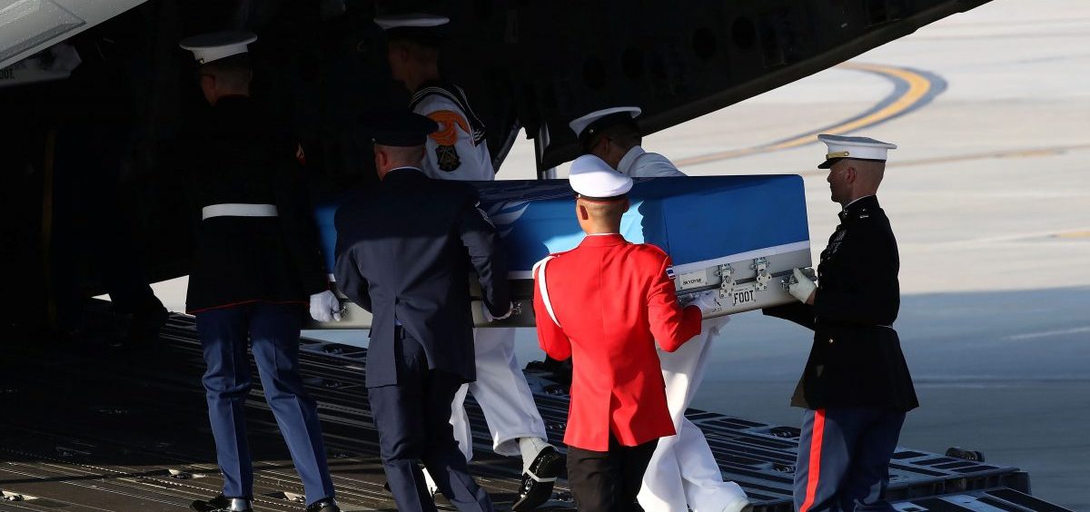 U.N. honor guards carry a casket containing remains transferred by North Korea onto a plane at Osan Air Base in Pyeongtaek, South Korea, on Wednesday. The remains will be analyzed in Hawaii to determine whether they are those of U.S. service members missing since the Korean War.