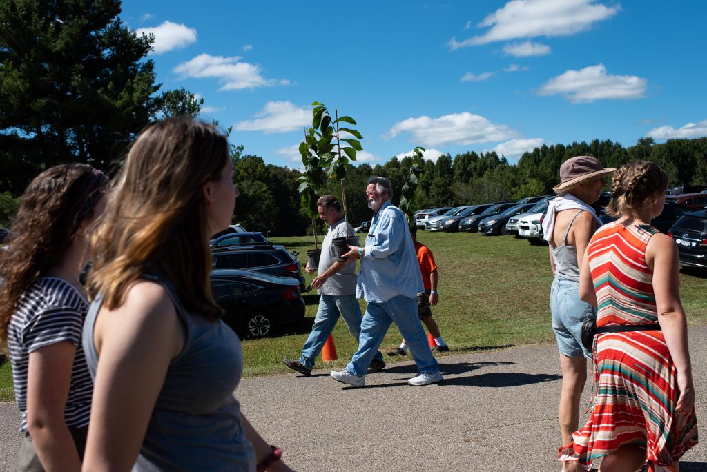 Pawpaw plants are carried out of the 20th Annual Festival in Albany, Ohio on Saturday, September 15, 2018. (Nickolas Oatley/WOUB)