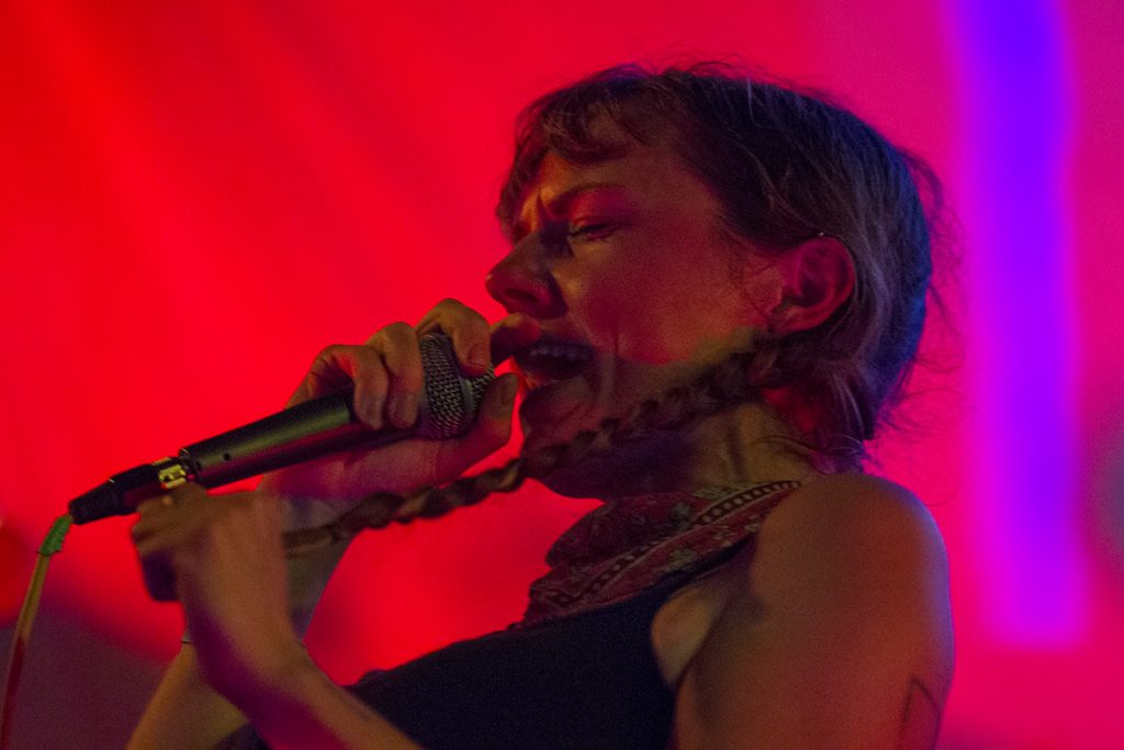 Kassie Carlson, vocalist for the band Guerilla Toss sings into the microphone during Falloutfest 2018 on Friday, Sept. 21, 2018, at The Union in Athens, Ohio. (Charles Hatcher/WOUB)