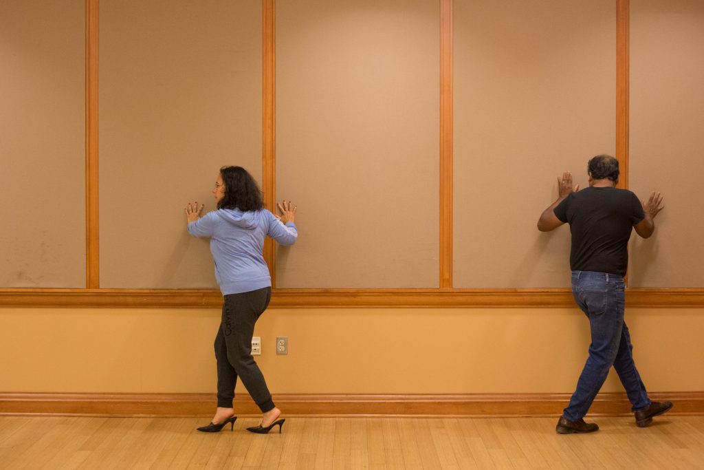 Claudia González Vallejo (left) and Chris Demel use the wall to practice the back ocho during Tango Club in Baker Student Center at Ohio University on Thursday, October 11, 2018. (Hannah Schroeder/ WOUB)