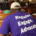 Faith-based groups from both sides of the political spectrum are working to inspire voters for the midterms. A man listens as Black Voters Matter co-founder LaTosha Brown speaks at a church as part of The South Rising Tour, aimed at getting more voters to the polls.