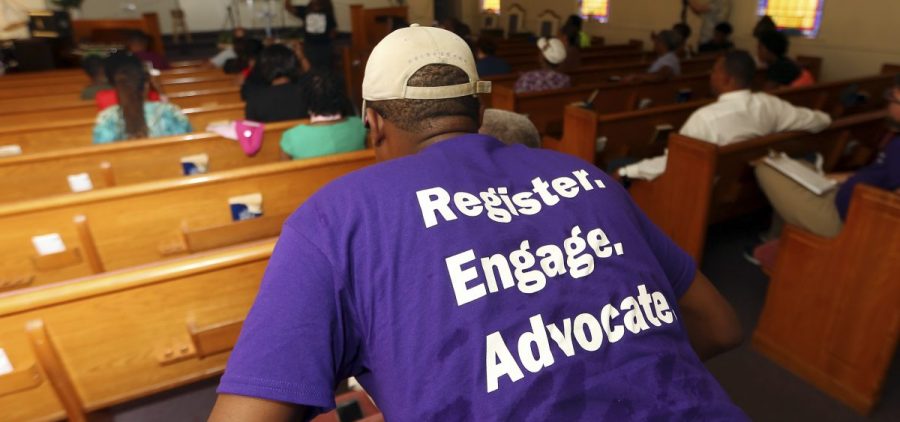 Faith-based groups from both sides of the political spectrum are working to inspire voters for the midterms. A man listens as Black Voters Matter co-founder LaTosha Brown speaks at a church as part of The South Rising Tour, aimed at getting more voters to the polls.