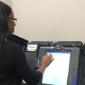 Sharyn Rigsbee demonstrates special voting machine.