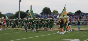 Athens High School football team runs onto the field