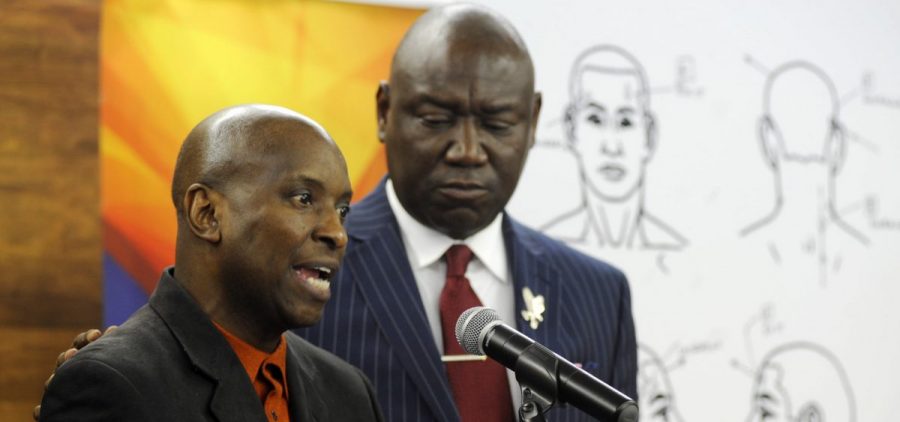 Flanked by attorney Ben Crump, Emantic Bradford Sr. discusses the results of a forensic examination on his son Emantic "EJ" Bradford Jr., who was fatally shot by police after a shooting in a shopping mall on Thanksgiving Day, after being mistaken for a suspect.