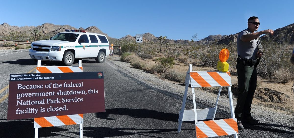 A U.S. park ranger gives a tourist suggestions of other nearby places he can visit while Joshua Tree National Park was shut down in 2013.