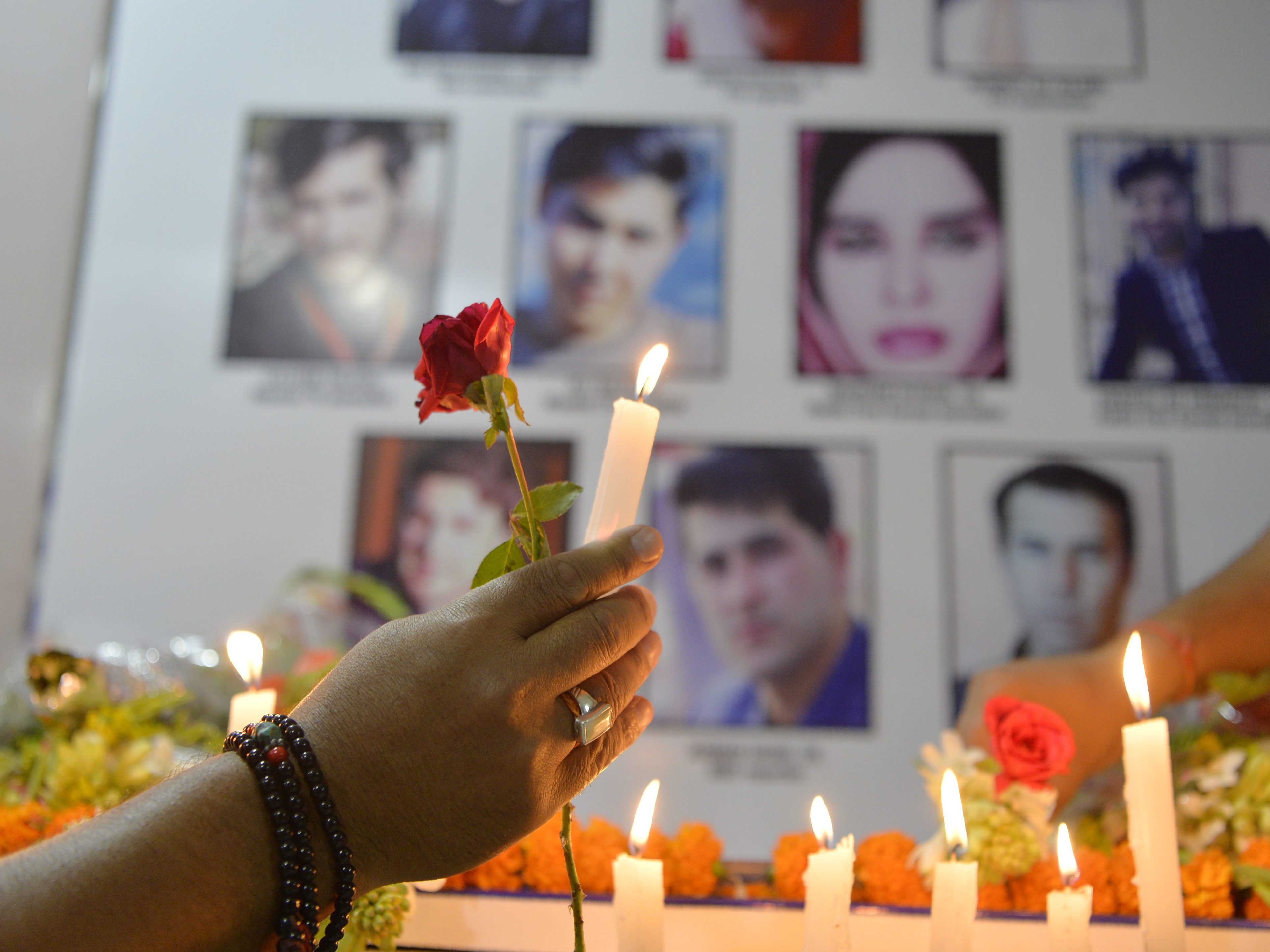 Journalists light candles in Siliguri, India, on May 3, during a vigil for Afghan journalists who were killed in a targeted suicide bombing in Kabul on April 30.