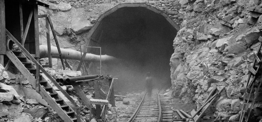 Dust circles a worker during the construction of the Hawks Nest Tunnel in 1930. Workers on the project were exposed to toxic levels of silica dust; hundreds ultimately died.
