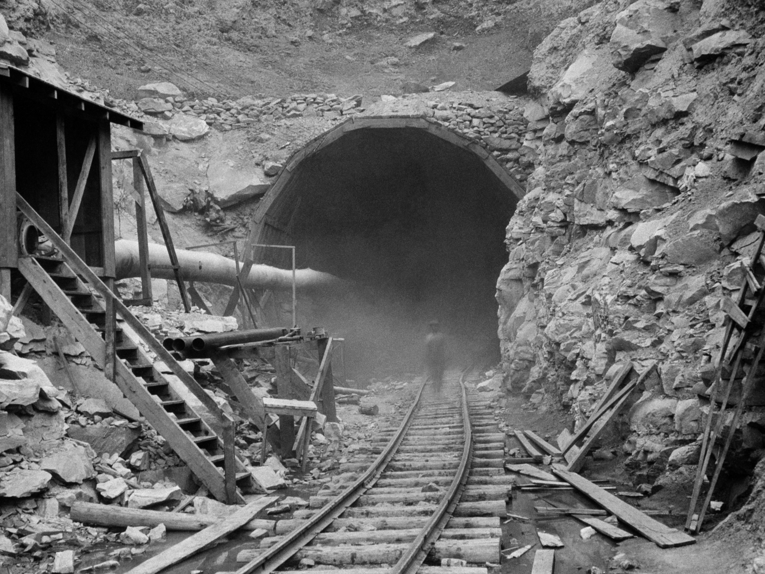 Dust circles a worker during the construction of the Hawks Nest Tunnel in 1930. Workers on the project were exposed to toxic levels of silica dust; hundreds ultimately died.