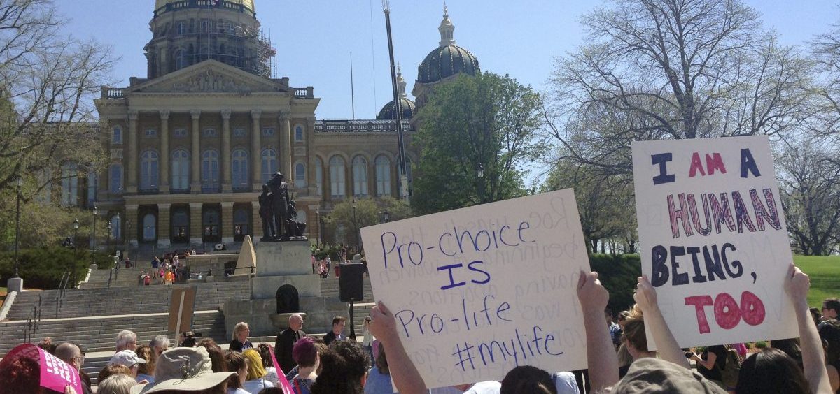 Abortion-rights advocates rally outside the Iowa capitol building in May. A law there banning abortion after a fetal heartbeat is detected is one of several state laws on its way through the courts.