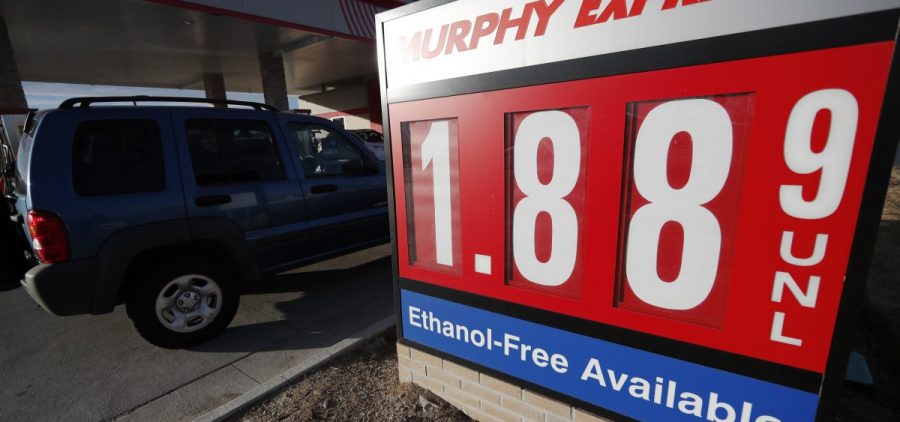 Motorists drive past a sign advertising regular gasoline at $1.88 per gallon at a station in Longmont, Colo., on Dec. 22, 2018. Falling gasoline prices have given drivers a little extra cheer this winter.