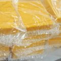 Cheese is packaged for sale at Widmer's Cheese Cellars in 2016 in Theresa, Wis. Record dairy production in the U.S. has produced a record surplus of cheese causing prices to drop.