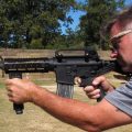 Shooting instructor Frankie McRae aims an AR-15 rifle fitted with a "bump stock" that allows the semi-automatic to shoot as fast as an illegal machine gun. As of March 26, bump stocks will be effectively illegal to own unless a court puts an injunction on the federal ban.
