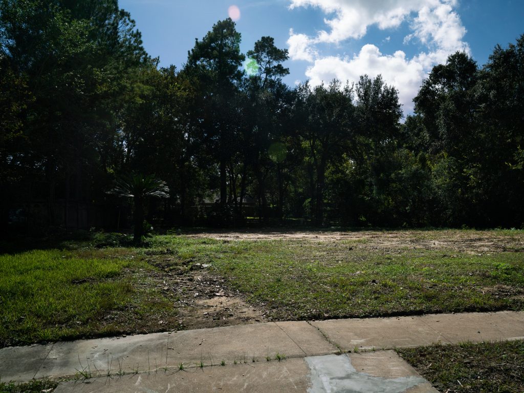 The empty lot of land where John and Heather Papadopoulos' home once stood on Bayou Glen Road.